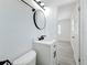 Modern bathroom offers a sleek round mirror and stylish lighting fixture at 200 Lewis Se Blvd, St Petersburg, FL 33705
