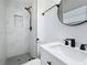 Renovated bathroom showcasing a stunning marble shower and black hardware at 200 Lewis Se Blvd, St Petersburg, FL 33705
