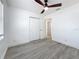 Bedroom featuring a ceiling fan, gray wood-look floors, and a closet at 200 Lewis Se Blvd, St Petersburg, FL 33705
