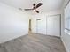 Bedroom featuring gray wood-look floors, a ceiling fan, and a closet at 200 Lewis Se Blvd, St Petersburg, FL 33705