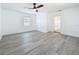 Bedroom with neutral colors, gray flooring, a window, and a ceiling fan at 200 Lewis Se Blvd, St Petersburg, FL 33705