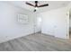 Bright bedroom features a ceiling fan, and gray wood-look flooring at 200 Lewis Se Blvd, St Petersburg, FL 33705