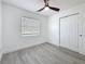 Bedroom featuring a ceiling fan, a window with blinds, and a closet at 200 Lewis Se Blvd, St Petersburg, FL 33705