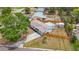An aerial view showcases the home with a well-manicured lawn, shed, and fenced yard at 200 Lewis Se Blvd, St Petersburg, FL 33705