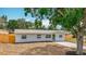 Charming single-story home featuring a well-maintained lawn, light colored paint, and a quaint green door at 200 Lewis Se Blvd, St Petersburg, FL 33705