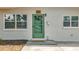 Inviting front entrance with a freshly painted door, decorative hardware, and manicured lawn at 200 Lewis Se Blvd, St Petersburg, FL 33705