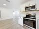 This modern kitchen offers stainless steel appliances, subway tile, and wood grain floors at 200 Lewis Se Blvd, St Petersburg, FL 33705