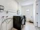 Updated laundry area with black washer and dryer appliances at 200 Lewis Se Blvd, St Petersburg, FL 33705