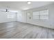 Spacious living room with wood grain floors, ceiling fan, multiple windows, and modern finishes at 200 Lewis Se Blvd, St Petersburg, FL 33705