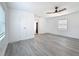 Bright living room with ceiling fan, windows with blinds, white walls and floors, and neutral decor at 200 Lewis Se Blvd, St Petersburg, FL 33705