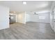 Bright living room featuring wood grain floors, white walls, and stainless steel appliances at 200 Lewis Se Blvd, St Petersburg, FL 33705