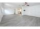 Spacious living area showcasing gray wood-look flooring, and easy access to kitchen at 200 Lewis Se Blvd, St Petersburg, FL 33705