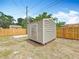 Backyard view of a metal storage shed with a wooden door, perfect for storing all your outdoor equipment at 200 Lewis Se Blvd, St Petersburg, FL 33705