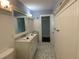 Charming bathroom with beadboard paneling, marble countertops, and stylish fixtures at 209 Rosery Rd, Belleair, FL 33756