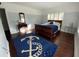 Bright bedroom with hardwood floors, shuttered windows, and a charming anchor area rug at 209 Rosery Rd, Belleair, FL 33756