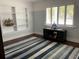 Cozy bedroom with a built-in bookcase, shuttered window, and striped rug at 209 Rosery Rd, Belleair, FL 33756