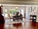 Elegant dining room with large windows, hardwood floors, and stylish furnishings at 209 Rosery Rd, Belleair, FL 33756