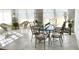 Bright dining room with a glass table, iron chairs, tile floors and natural light at 209 Rosery Rd, Belleair, FL 33756