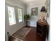 Welcoming foyer featuring an antique cabinet, elegant decor, and light-filled double front doors at 209 Rosery Rd, Belleair, FL 33756