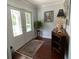 Elegant foyer features a decorative rug, hardwood floors, and stylish accents at 209 Rosery Rd, Belleair, FL 33756