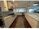 Bright and spacious kitchen featuring white cabinets, modern appliances, and hardwood flooring at 209 Rosery Rd, Belleair, FL 33756