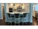 Modern kitchen with barstool seating, stainless steel appliances, and stylish pendant lighting at 209 Rosery Rd, Belleair, FL 33756