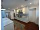 Bright and spacious kitchen featuring white cabinets, modern appliances, and hardwood flooring at 209 Rosery Rd, Belleair, FL 33756
