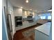 Bright and spacious kitchen featuring white cabinets, modern appliances, and hardwood flooring at 209 Rosery Rd, Belleair, FL 33756