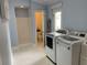 Functional laundry room with modern washer and dryer, and access to a shower and toilet at 209 Rosery Rd, Belleair, FL 33756