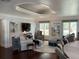 Bright living room with hardwood floors, stylish furnishings, and a unique recessed ceiling design at 209 Rosery Rd, Belleair, FL 33756