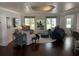 Bright living room with hardwood floors, stylish furnishings, and a unique recessed ceiling design at 209 Rosery Rd, Belleair, FL 33756