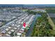 Aerial view of waterfront homes in a vibrant community with canal access and green spaces at 210 N Saint Thomas Cir, Apollo Beach, FL 33572