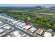 Aerial view of a home next to a canal and close to an industrial park at 210 N Saint Thomas Cir, Apollo Beach, FL 33572