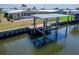 Covered dock with a boat lift situated on a waterfront canal at 210 N Saint Thomas Cir, Apollo Beach, FL 33572