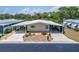Charming single-story home with a carport, well-maintained landscaping, and welcoming curb appeal at 210 N Saint Thomas Cir, Apollo Beach, FL 33572