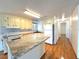 Modern kitchen with an island and white appliances, cabinets, and backsplash at 210 N Saint Thomas Cir, Apollo Beach, FL 33572