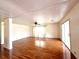Open living room with light hardwood floors and glass sliding door at 210 N Saint Thomas Cir, Apollo Beach, FL 33572