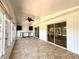 Large sunroom with tile flooring, ceiling fan and access to the backyard at 210 N Saint Thomas Cir, Apollo Beach, FL 33572