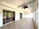 Bright sunroom featuring tile floor, ceiling fan, and glass sliding doors at 210 N Saint Thomas Cir, Apollo Beach, FL 33572