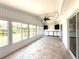 Spacious sunroom with tile floor, ceiling fan and scenic views at 210 N Saint Thomas Cir, Apollo Beach, FL 33572
