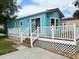 Charming turquoise home with a welcoming deck and white lattice trim at 21034 Lirio Dr, Land O Lakes, FL 34637