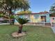 Bright blue home featuring a large deck, neat landscaping, and curb appeal at 21034 Lirio Dr, Land O Lakes, FL 34637