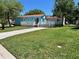 Inviting light blue single Gathering home with a beautiful lawn and a concrete walkway leading to the front porch at 21034 Lirio Dr, Land O Lakes, FL 34637