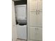 Convenient laundry area with stacked washer and dryer, plus built-in linen storage at 21034 Lirio Dr, Land O Lakes, FL 34637