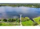 Scenic aerial view of lake with long wooden dock, surrounded by lush greenery, offering serene waterfront access at 2436 Rhodesian Dr # 24, Clearwater, FL 33763