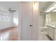 A full bathroom with walk in shower and tiled floors is seen through a doorway at 2436 Rhodesian Dr # 24, Clearwater, FL 33763