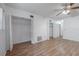 Spacious bedroom featuring hardwood floors, a ceiling fan, and ample closet space at 2436 Rhodesian Dr # 24, Clearwater, FL 33763
