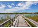 Wooden dock extends onto lake, great spot for enjoying nature and the tranquility of waterfront living at 2436 Rhodesian Dr # 24, Clearwater, FL 33763