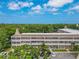 This exterior view shows the well maintained landscaping and building facade at 2436 Rhodesian Dr # 24, Clearwater, FL 33763