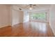Spacious living room with hardwood floors, a ceiling fan, and natural light from large windows at 2436 Rhodesian Dr # 24, Clearwater, FL 33763